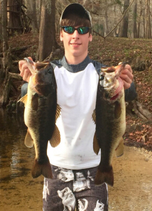 Jake Hartley with two nice Santa Fe River bass, caught on soft plastic baits.