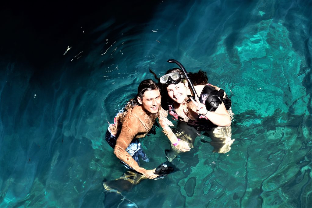 Couple in snorkel gear in the clear blue water of Devil's Den Springs