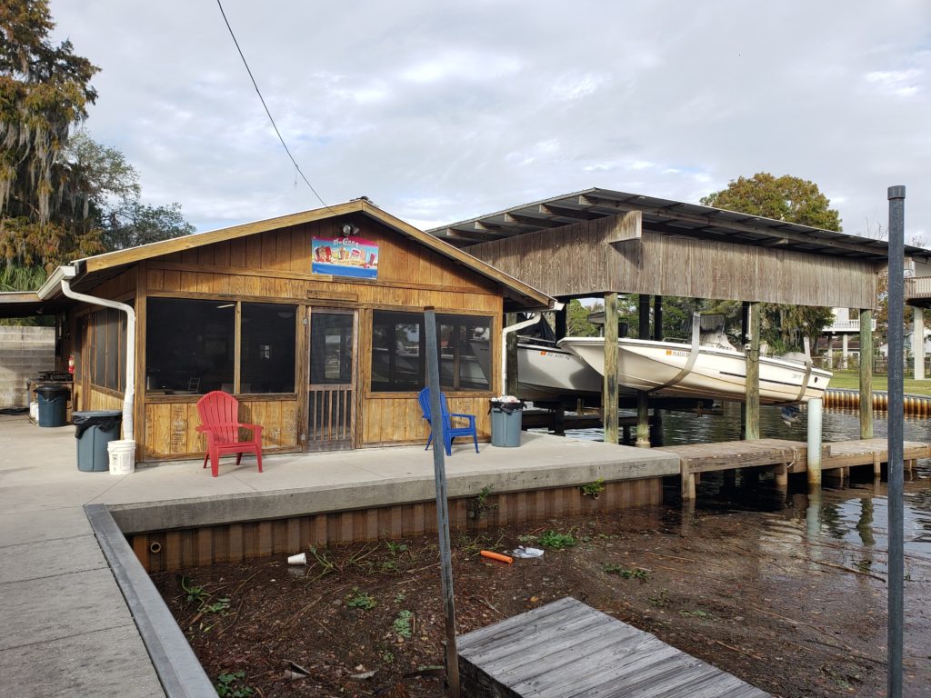 screened-in building next to dock