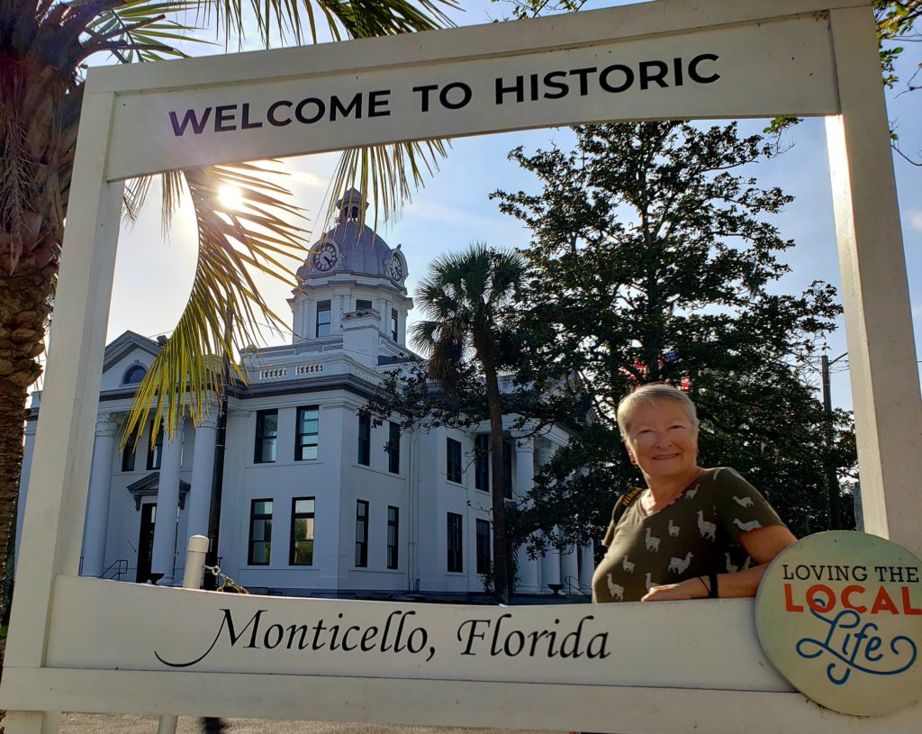 Woman in a frame with historic courthouse in background