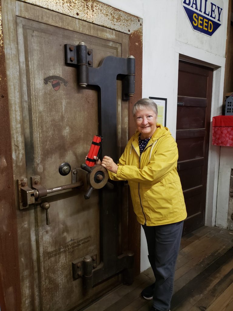 Lady with fake TNT attempting to "blow" the safe in the hardware store