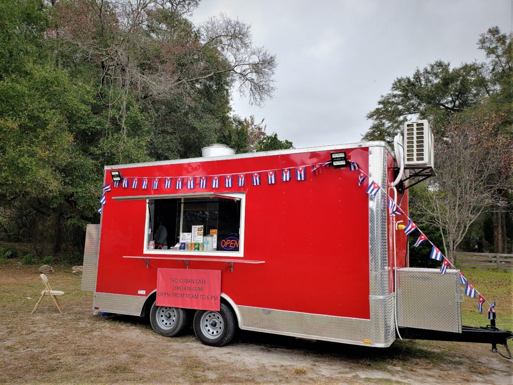 Bright red food truck serving Cuban food