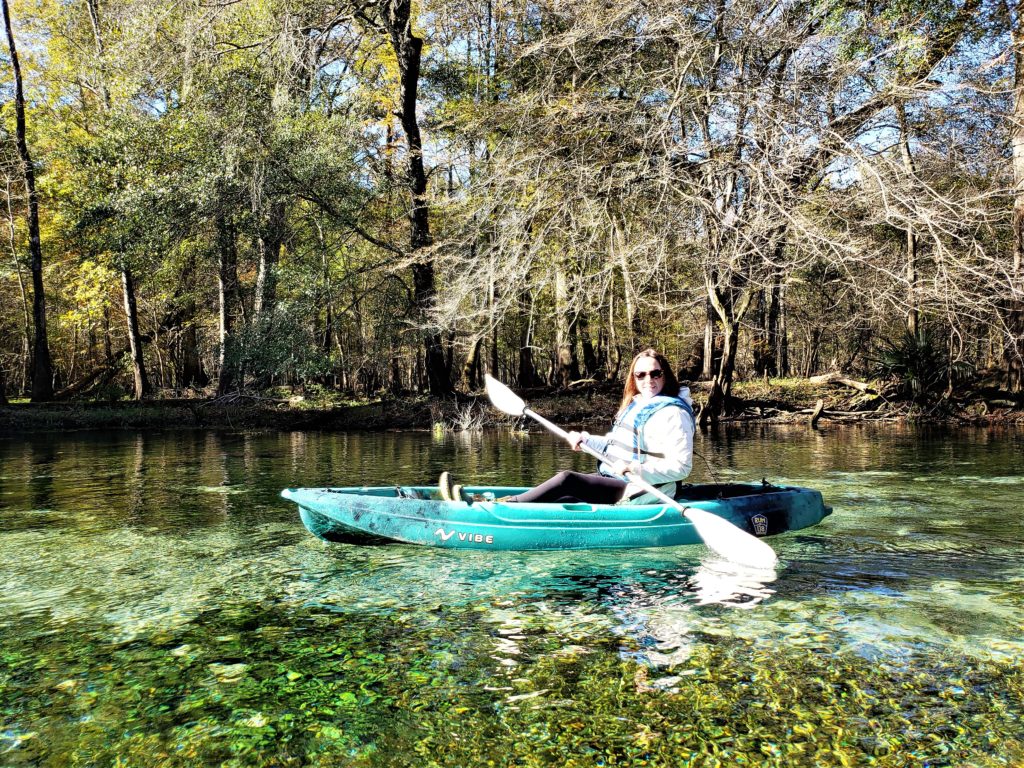 Woman kayaking in green spring