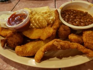 platter with catfish and waffle fries, and  beans in a separate bowl