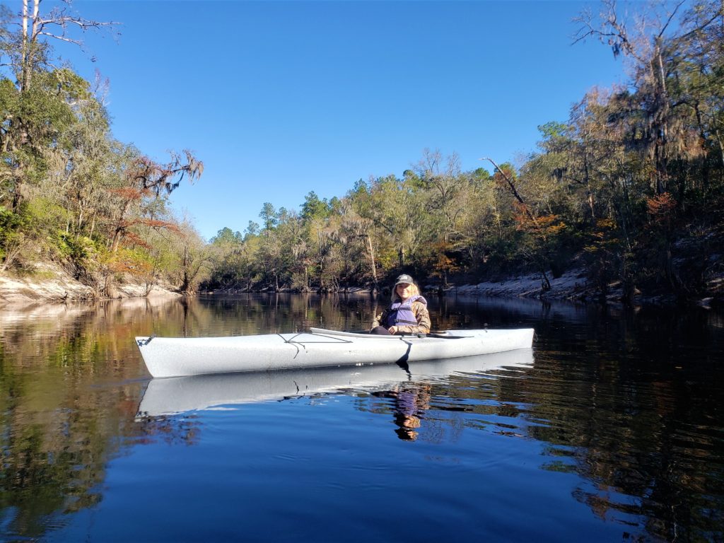 Woman in canoe on river