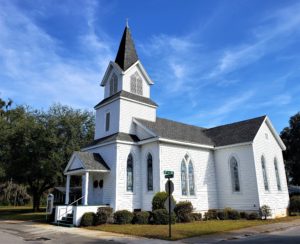 1878 Church - white, tall steeple, gothic shaped stained glass