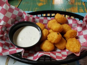 basket lined with red checked paper, and filled with hot corn nuggets
