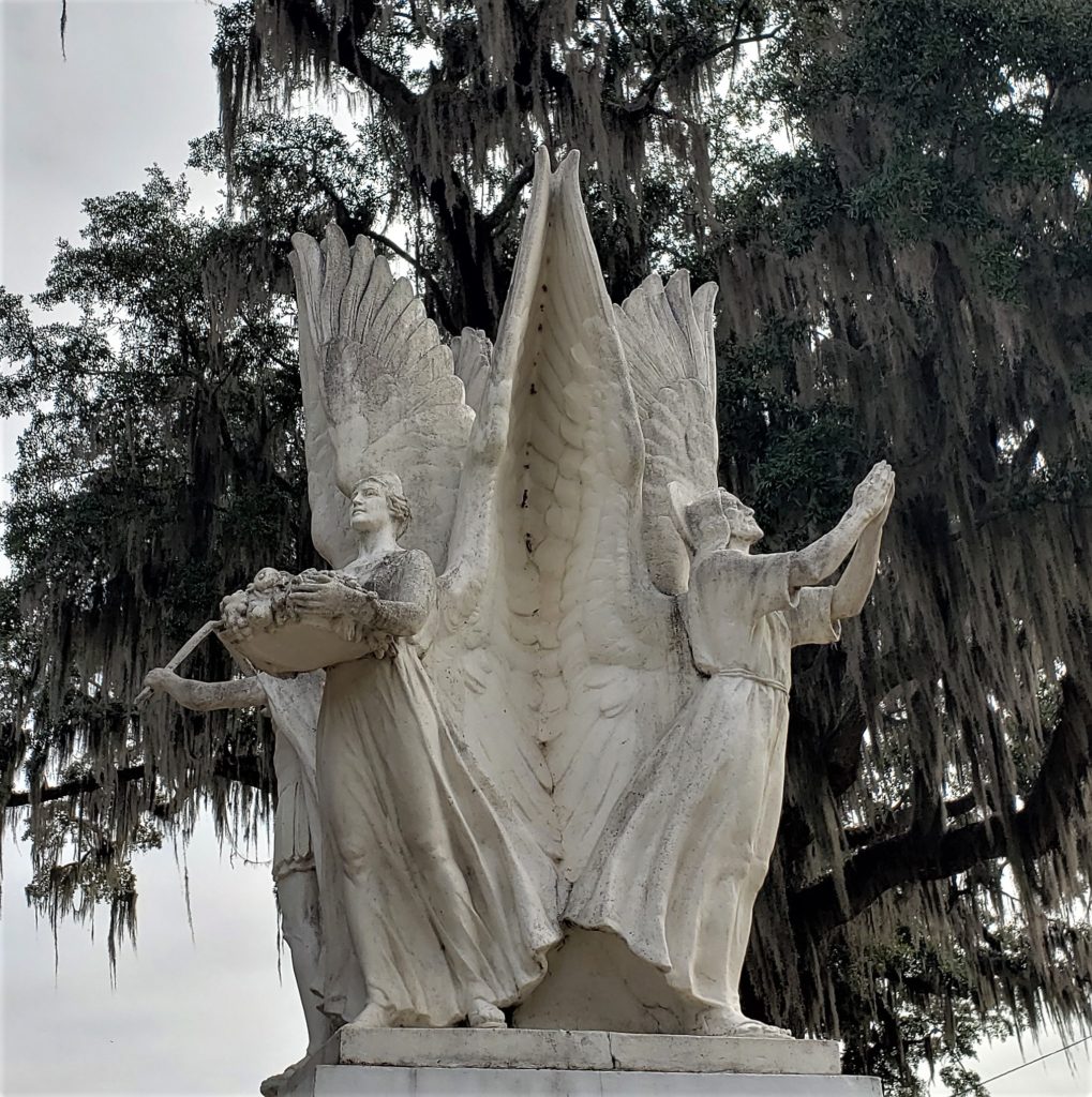 White Marble statue in park, angels back to back forming a square - representing Freedom of Speech, Freedom of Worship, Freedom from Want, and Freedom from Fear.