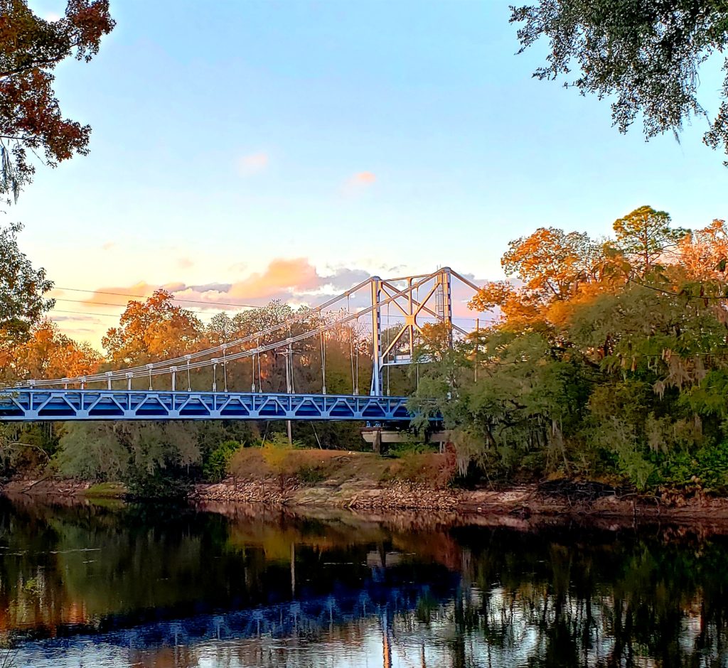 Blue suspension bridge over river