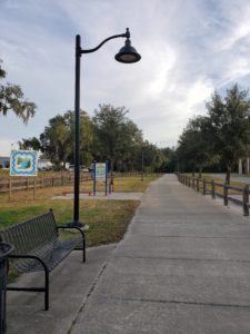 long concrete walking path with street light