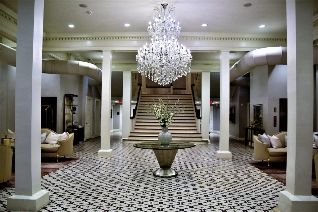 hotel lobby with tile floring and crystal chandelier